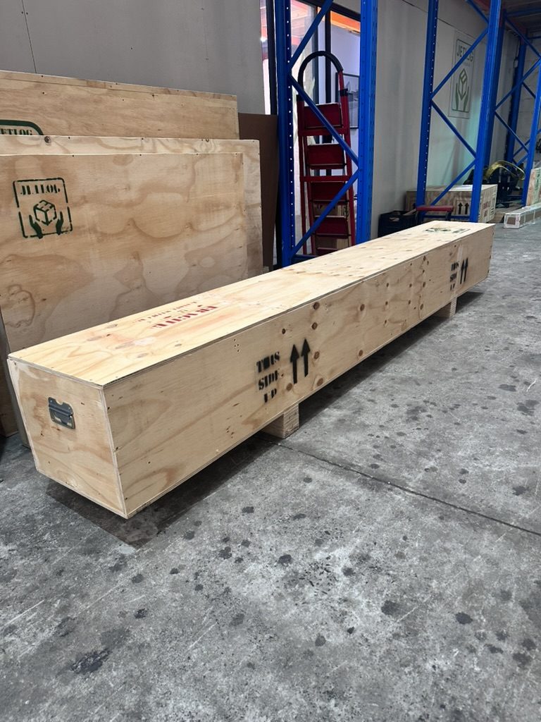 Long narrow timber crate with This Side Up markings for a long object, built by JLog in Cape Town